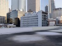 a view of the city through a roof deck overlooking the city's buildings on a clear day