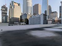 a view of the city through a roof deck overlooking the city's buildings on a clear day