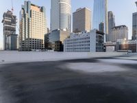a view of the city through a roof deck overlooking the city's buildings on a clear day