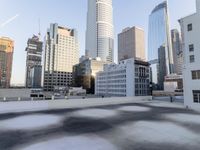 a view of the city through a roof deck overlooking the city's buildings on a clear day