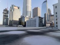 a view of the city through a roof deck overlooking the city's buildings on a clear day