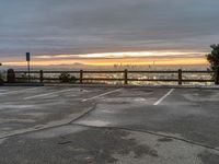 the view over the city from a parking lot at sunset with an umbrella nearby to protect against the sky