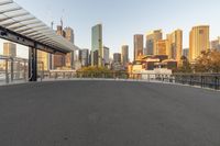 a cityscape with a view of a walkway, along side a building and an overhang