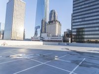 a picture of a parking lot with a bunch of skyscrapers in the background on a sunny day