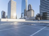 a picture of a parking lot with a bunch of skyscrapers in the background on a sunny day