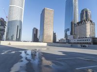 a picture of a parking lot with a bunch of skyscrapers in the background on a sunny day