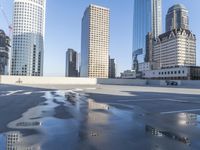 a picture of a parking lot with a bunch of skyscrapers in the background on a sunny day