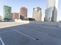 a picture of a parking lot with a bunch of skyscrapers in the background on a sunny day