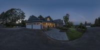 a picture taken from the front of a house at dusk in the evening with an outside patio