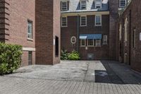 an empty brick alley with a fire hydrant next to it and buildings behind it