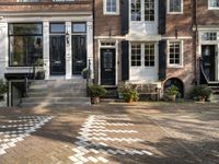 a black and white checkered pavement that is outside a building, with blue shutters