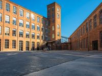 a large warehouse building with a blue sky in the background and windows on it's side