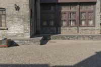 the person is walking down the street near old buildings on a sunny day with a red umbrella