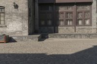 the person is walking down the street near old buildings on a sunny day with a red umbrella