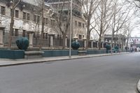 the large building is covered with ornate statues of trees in front of it on a sidewalk