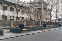 the large building is covered with ornate statues of trees in front of it on a sidewalk