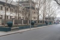 the large building is covered with ornate statues of trees in front of it on a sidewalk