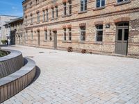 an old building has cobbles and stone walkways for visitors to see and play with