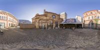 a photo taken in a fish - eye lens shows the entrance to an old city