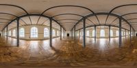 360 - view image of empty hall with arched ceiling and hard wood flooring with large windows and beams,