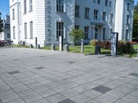 a building has multiple decorative post, in front of it and several bicycles parked around