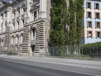 there is a large building on the corner of this street corner on a sunny day