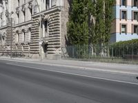 there is a large building on the corner of this street corner on a sunny day