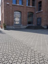 a brick walkway next to some buildings in the middle of town area, with text written in them