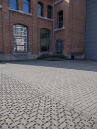 a brick walkway next to some buildings in the middle of town area, with text written in them