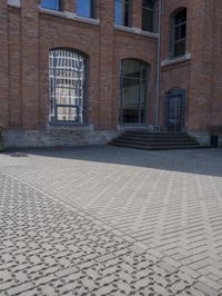 a brick walkway next to some buildings in the middle of town area, with text written in them