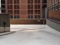 some stairs are near an empty ramp in front of buildings and some buildings near one another