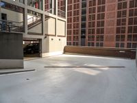 a car parked in a parking garage on a concrete surface, with a ramp and stairs visible