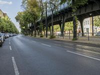 a bicycle is driving on a street and a bridge can be seen in the distance