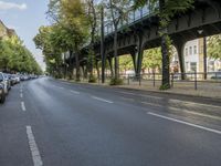 a bicycle is driving on a street and a bridge can be seen in the distance