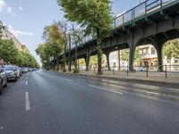 a bicycle is driving on a street and a bridge can be seen in the distance