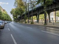 a bicycle is driving on a street and a bridge can be seen in the distance