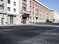 a building on the corner of a street with a car parked in front of it