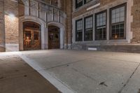 the entrance to an old brick building with a fire hydrant on the pavement in front of it