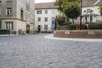 there is an old building in the background and a street sign for the street in front