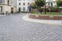 there is an old building in the background and a street sign for the street in front