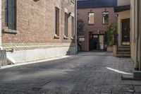 the brick walkways leading to the building have an arched window and light on them