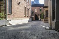 the brick walkways leading to the building have an arched window and light on them