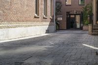 the brick walkways leading to the building have an arched window and light on them