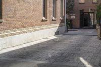 the brick walkways leading to the building have an arched window and light on them