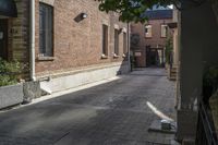 the brick walkways leading to the building have an arched window and light on them