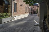 the brick walkways leading to the building have an arched window and light on them