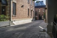 the brick walkways leading to the building have an arched window and light on them