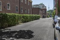 an empty street in the middle of a city with a car parked next to it