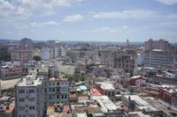 a large city with old buildings, some with red roofs and lots of other buildings