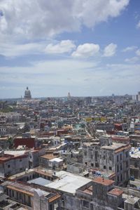 a large city with old buildings, some with red roofs and lots of other buildings